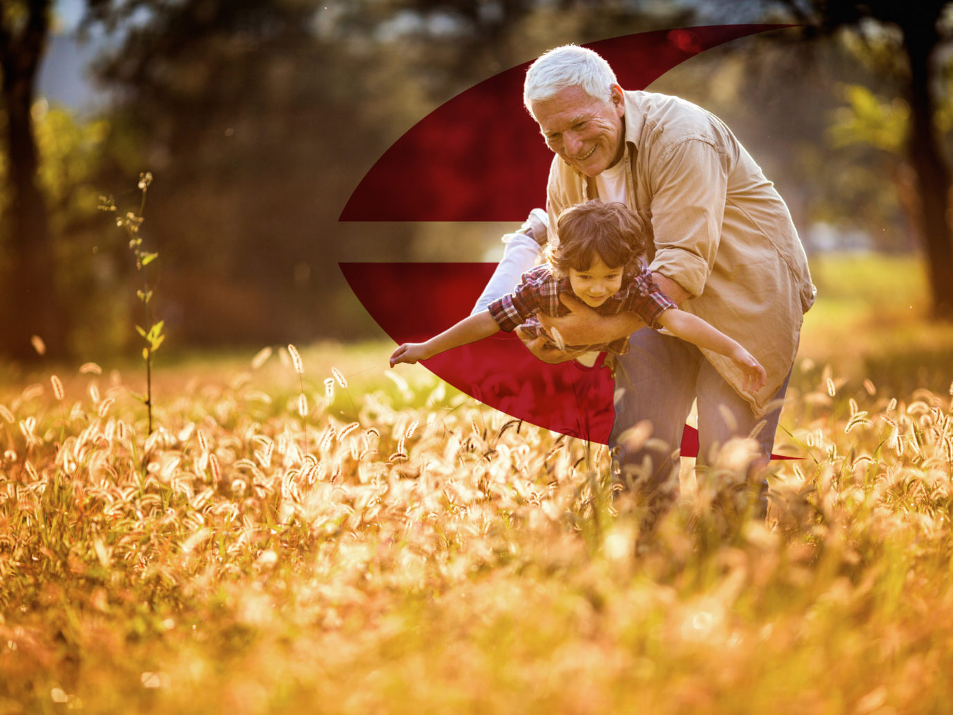 Close up of a playful grandfather playing with his grandson outdoors