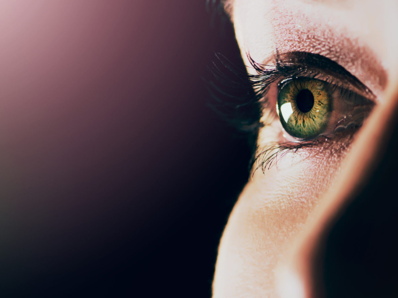 Studio shot of a man opening his eyes against a dark background