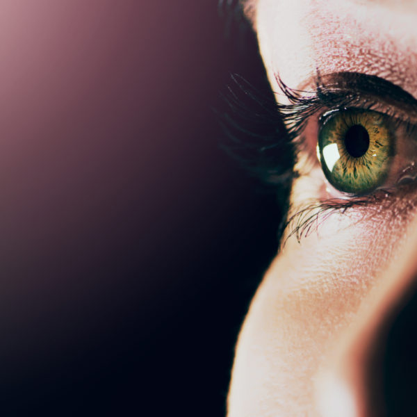 Studio shot of a man opening his eyes against a dark background