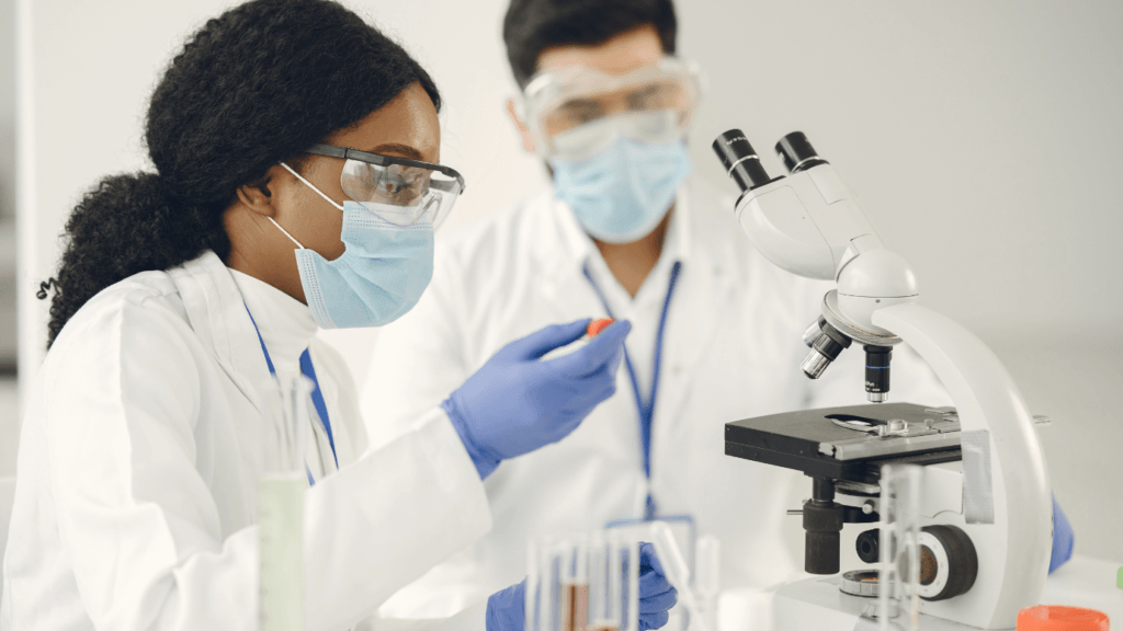 recruiting diverse candidates in biopharma scientists at microscope